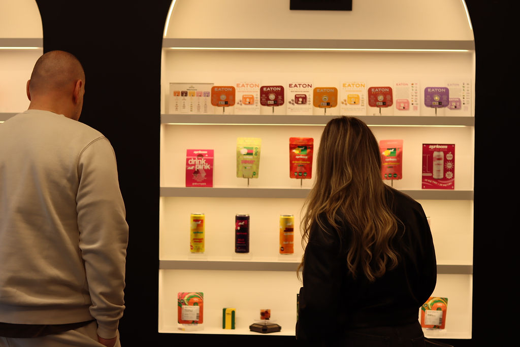 Customers looking at edibles on display at a cannabis shop